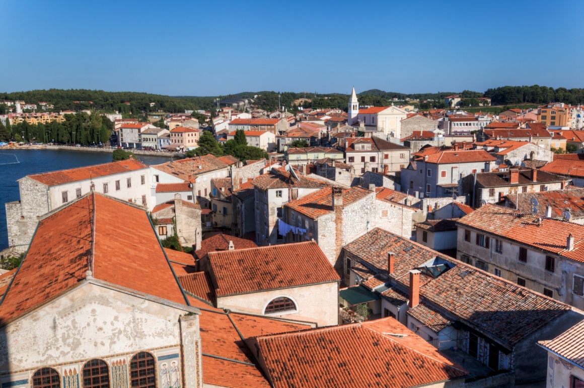 'aerial view over the roofs of the famous Croatian town Porec' - Istria
